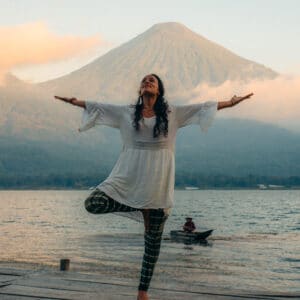 Women on dock in front of volcanos at yoga retreat Guatemala February 2025 at Mystical Yoga Farm