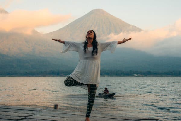 Women on dock in front of volcanos at yoga retreat Guatemala February 2025 at Mystical Yoga Farm